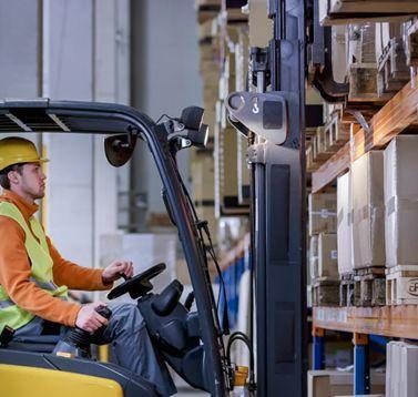 Warehouse worker in safety vest reviewing industrial fulfillment operations