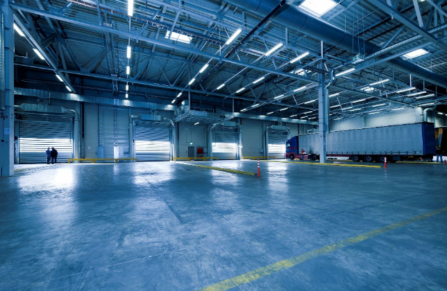 Interior of an industrial warehouse space for rent in Ontario with high ceilings and loading docks