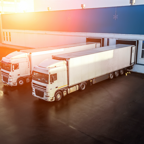 Transport trucks at the KAIN Logistics loading dock