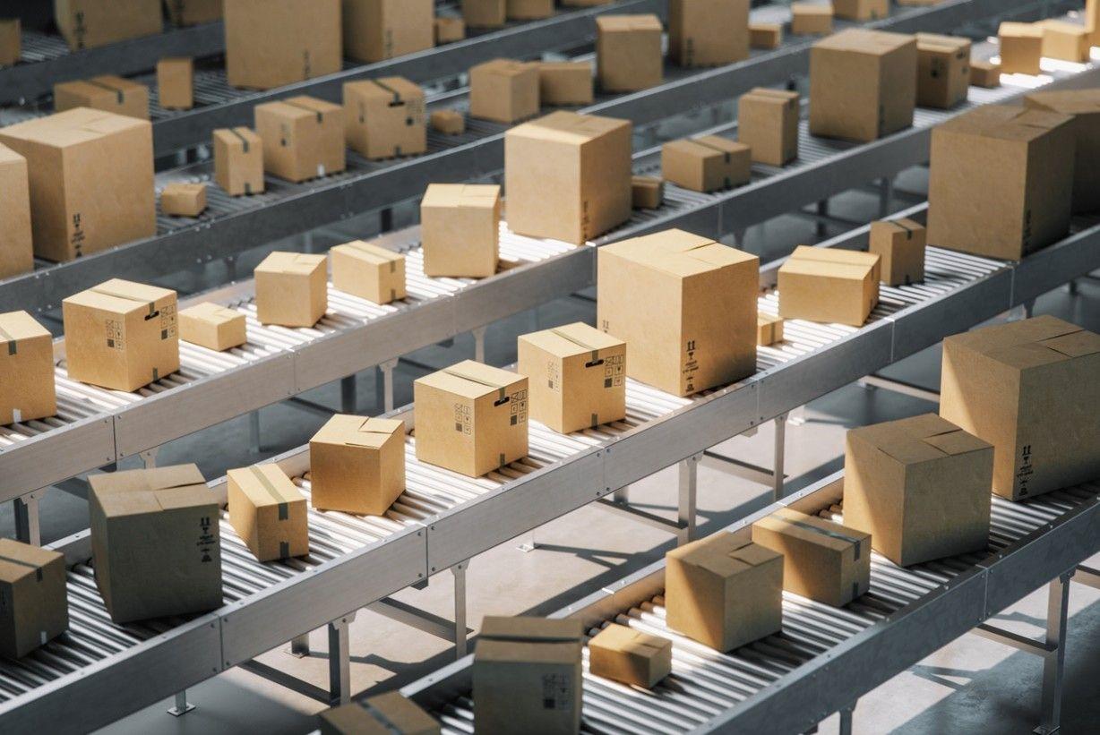Cardboard cartons moving along roller conveyors in a distribution centre