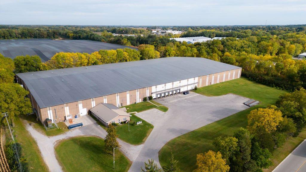 Aerial view of KAIN Logistics warehouse facility surrounded by trees